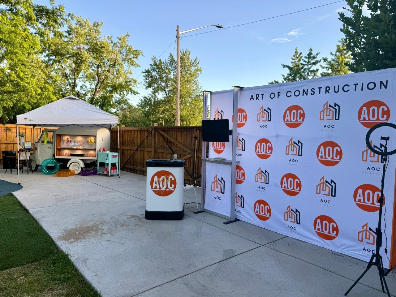 AOC backdrop and Cheers bar trailer at the 2026 Summertime Family Picnic